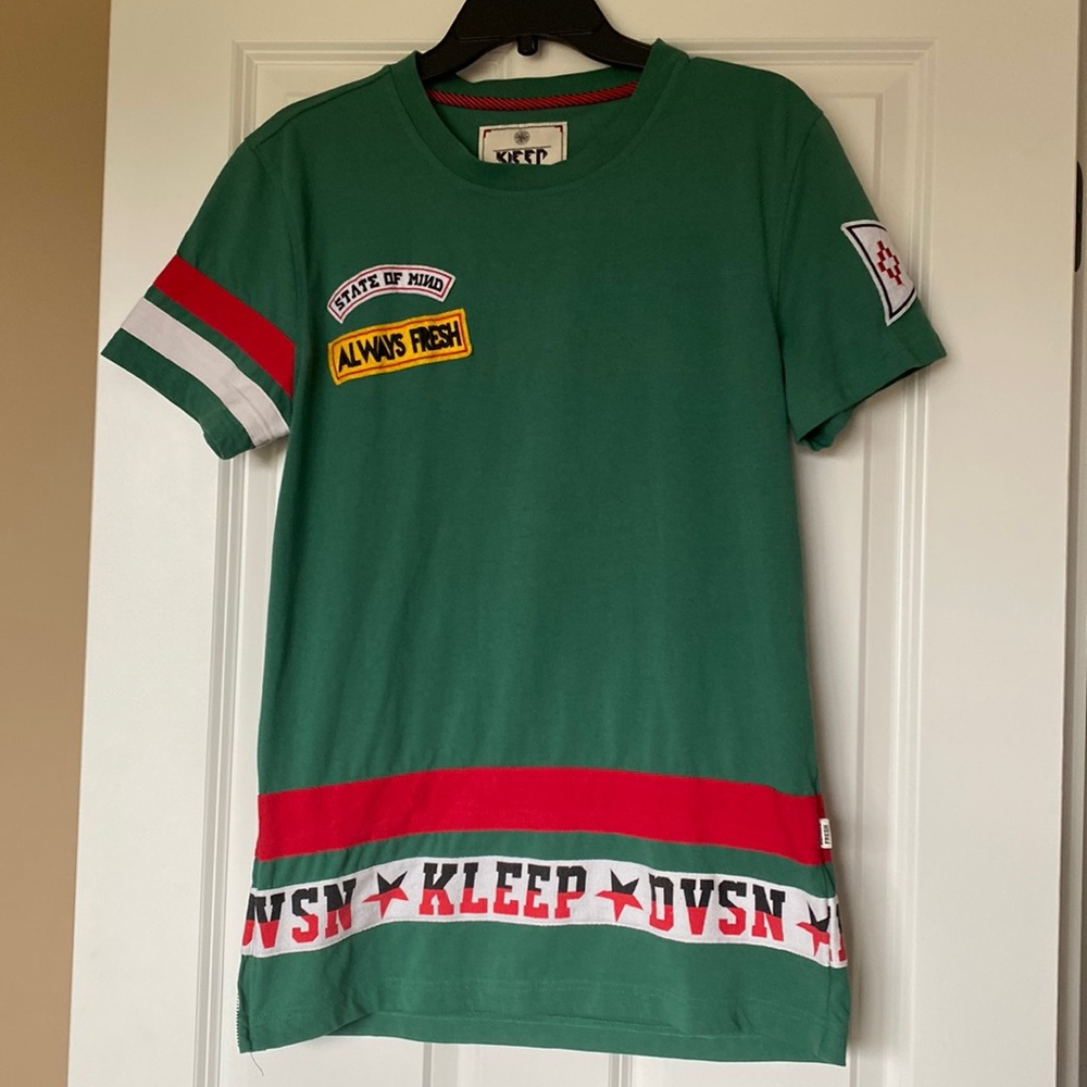 Kleep Tee with detail and side zip on one side.
